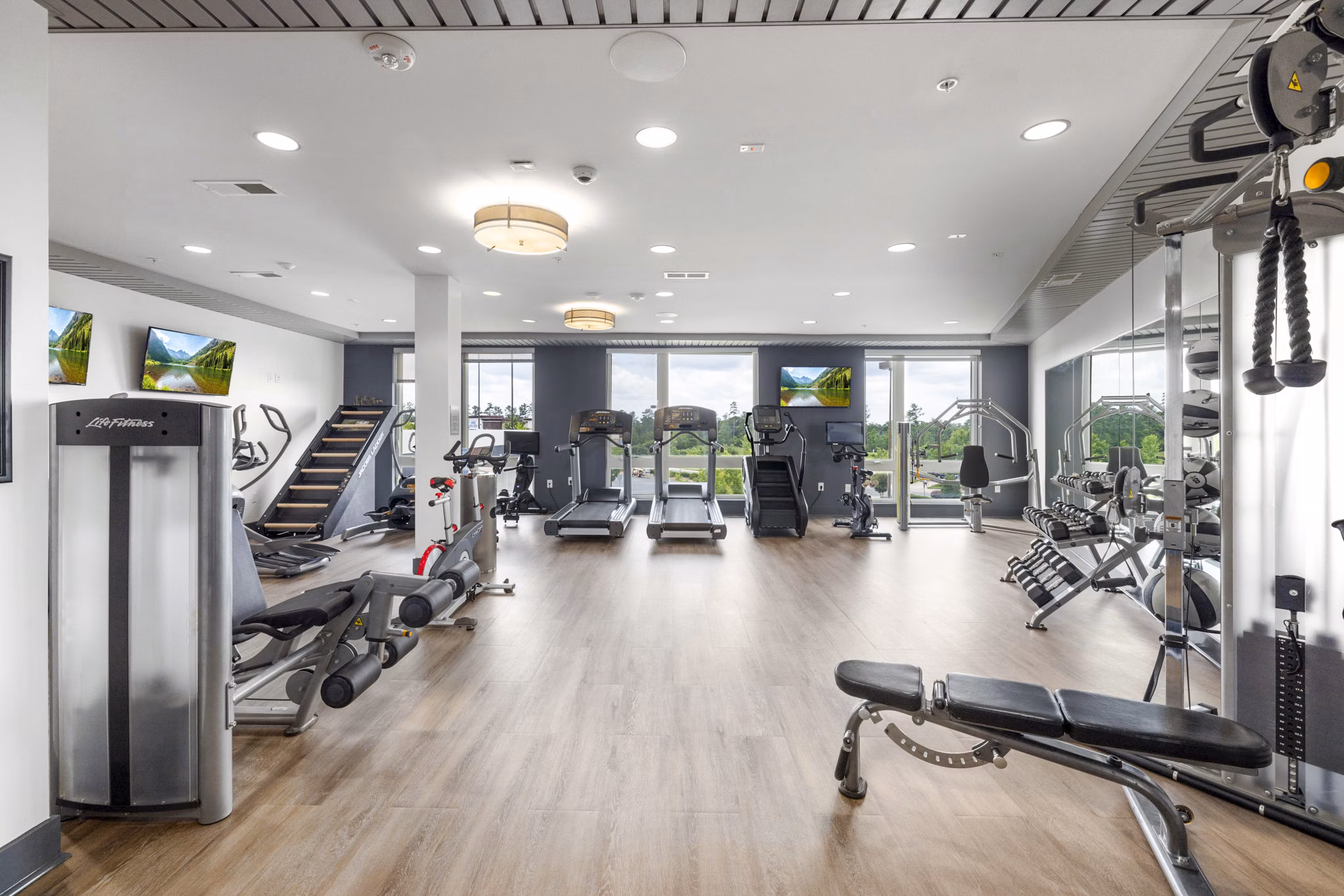 Modern fitness center with state-of-the-art equipment at District Lofts Apartments, offering luxury living for health-conscious residents