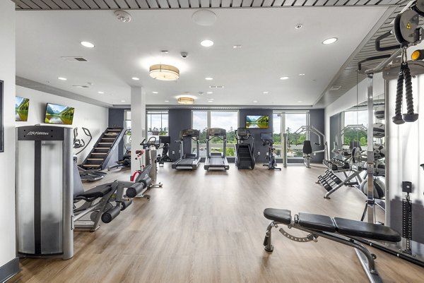 Modern fitness center with state-of-the-art equipment at District Lofts Apartments, offering luxury living for health-conscious residents