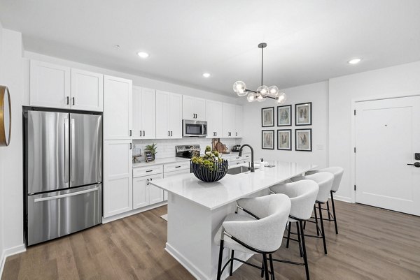Modern kitchen with stainless steel appliances at District Lofts Apartments