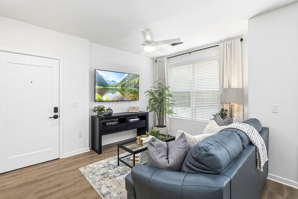 Spacious living room with modern decor in District Lofts Apartments