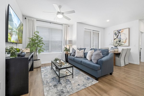 Spacious living room with contemporary decor at District Lofts Apartments