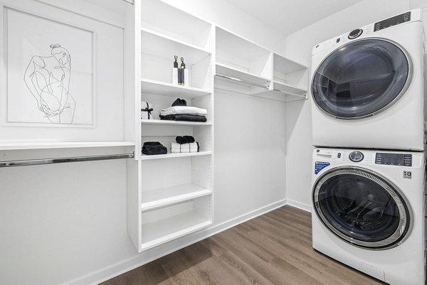 Laundry room with modern appliances in District Lofts Apartments