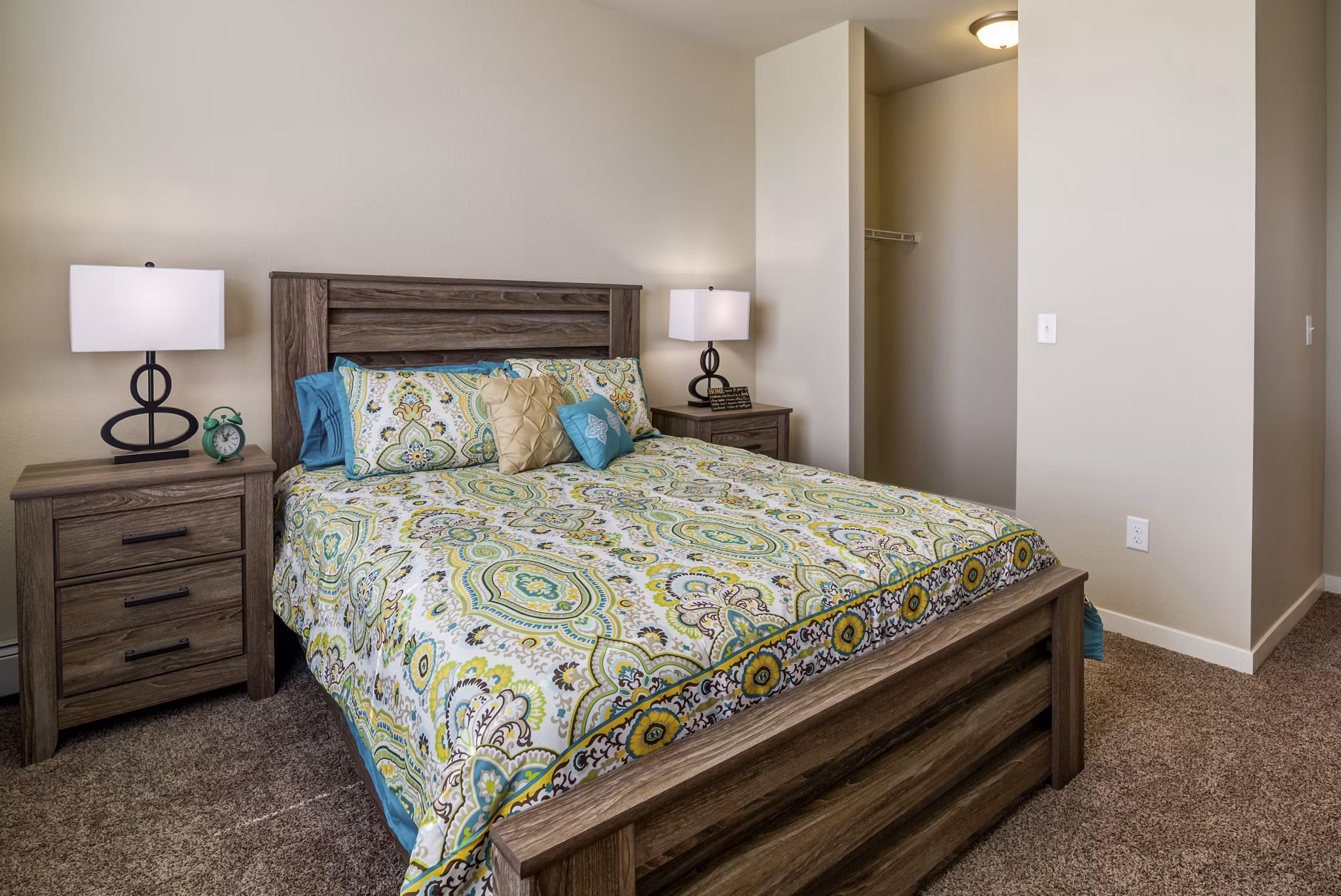 Elegant bedroom with large windows and contemporary furnishings in South Ridge Apartments