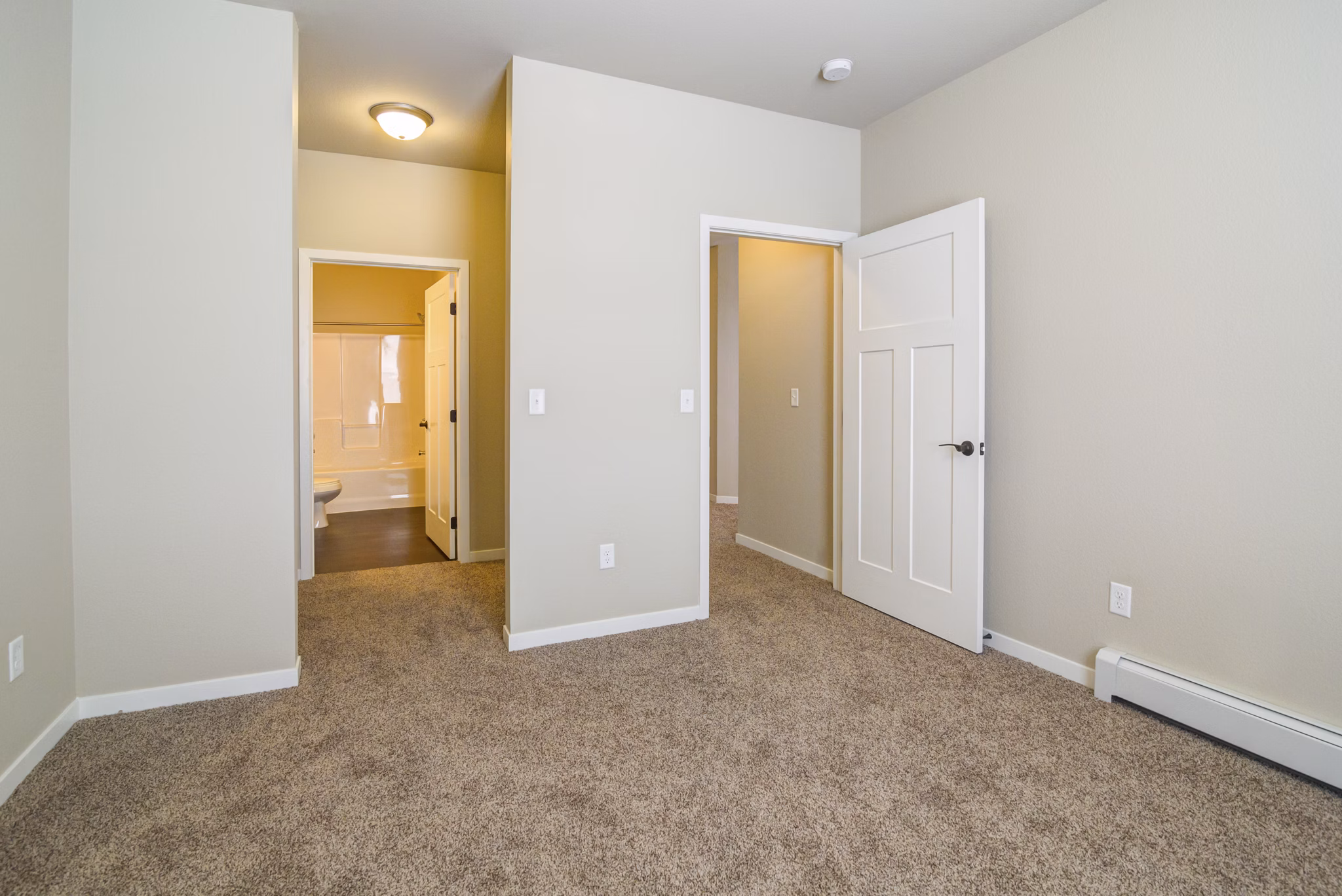 Cozy bedroom with modern furnishings at South Ridge Apartments featuring ample natural light and stylish decor
