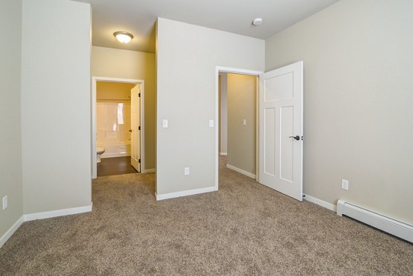 Cozy bedroom with modern furnishings at South Ridge Apartments featuring ample natural light and stylish decor