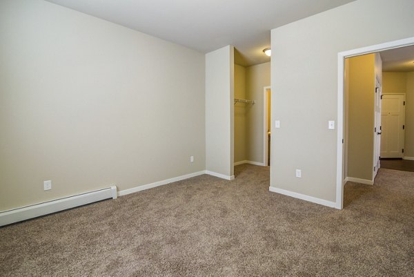 Cozy bedroom featuring stylish decor at South Ridge Apartments