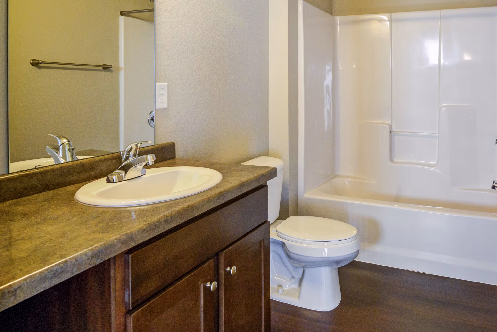 Modern bathroom with sleek fixtures and large mirror at South Ridge Apartments