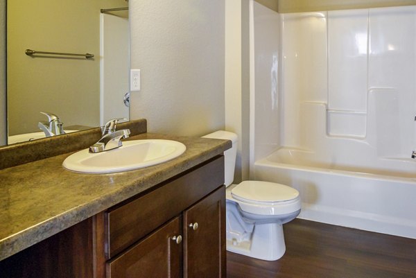 Modern bathroom with sleek fixtures and large mirror at South Ridge Apartments