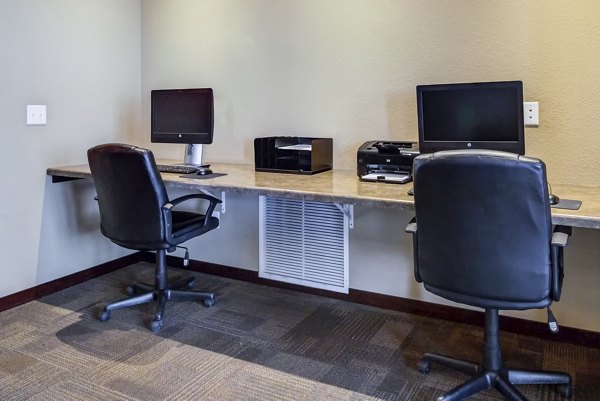 Business center equipped with modern workstations at South Ridge Apartments