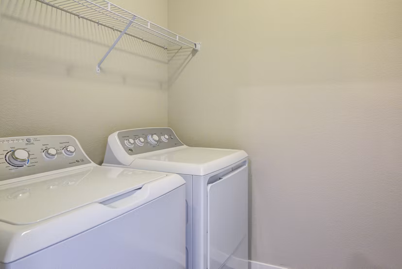 Laundry room featuring modern washers and dryers at South Ridge Apartments