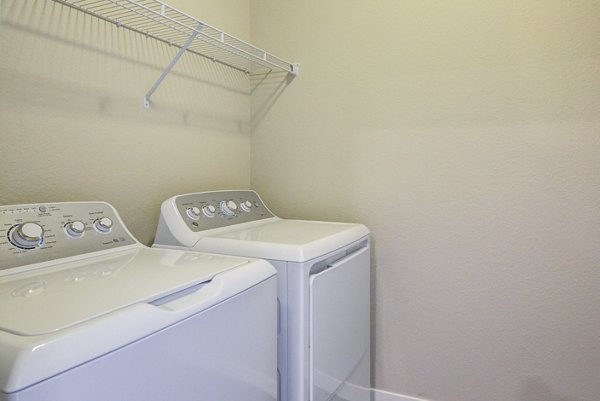Laundry room featuring modern washers and dryers at South Ridge Apartments