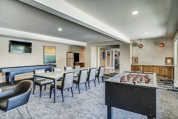 Clubhouse game room with billiards and seating area at Park 120 Apartments