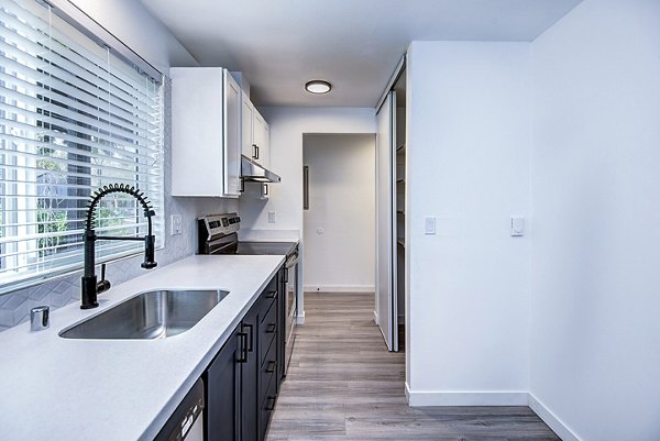 Contemporary kitchen with stainless steel appliances in Park 120 Apartments