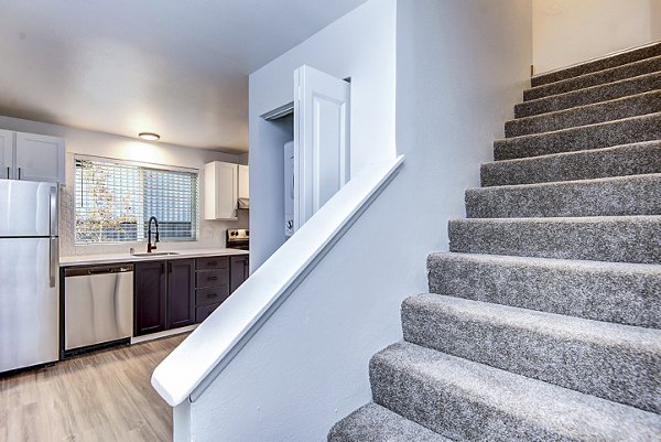 Living room with modern stairway design at Park 120 Apartments, showcasing luxury interiors in a Greystar community