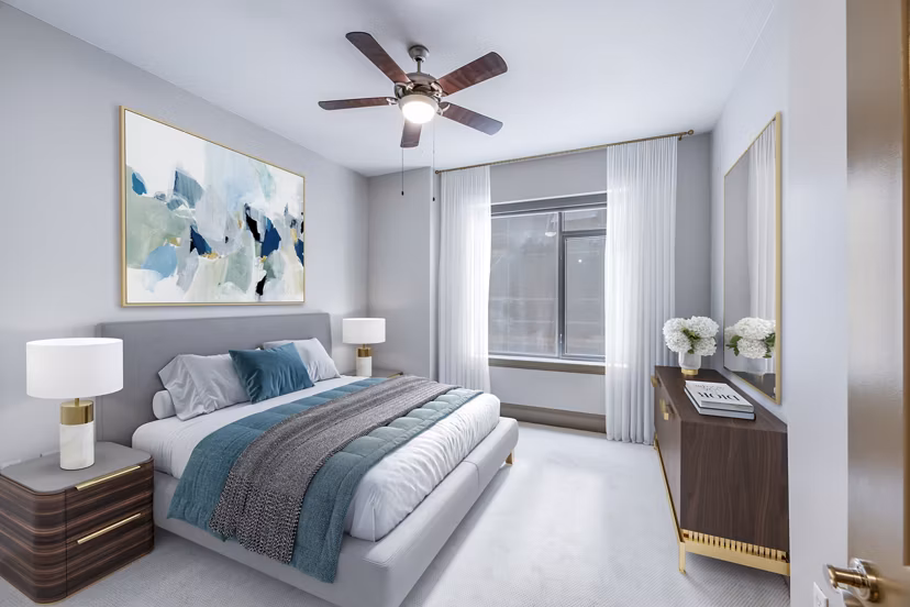Modern bedroom with plush bedding at Ashton at Judiciary Square Apartments