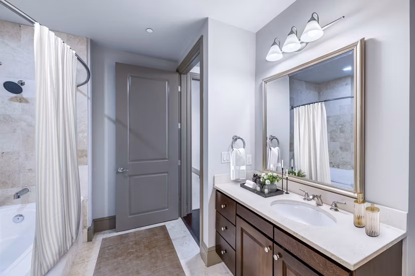 Luxurious bathroom with marble finish and modern fixtures at Ashton at Judiciary Square Apartments