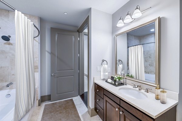 Luxurious bathroom with marble finish and modern fixtures at Ashton at Judiciary Square Apartments