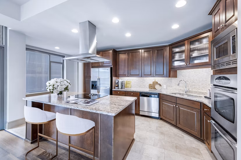 Modern kitchen with stainless steel appliances at Ashton at Judiciary Square Apartments, offering luxury living in a prime location