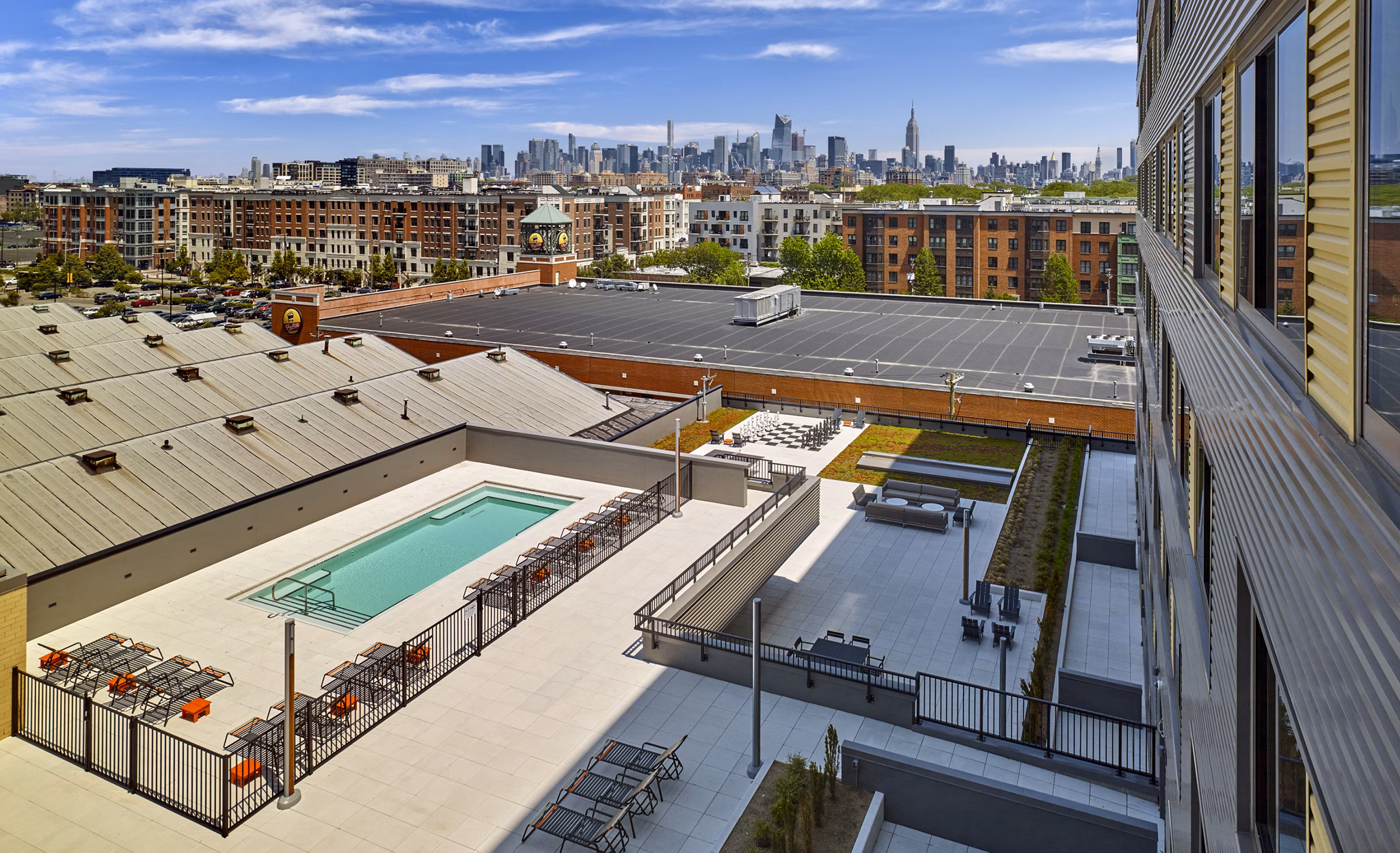Resort-style pool with lush landscaping at VINE Apartments, a luxury living experience by Greystar