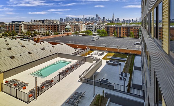 Resort-style pool with lush landscaping at VINE Apartments, a luxury living experience by Greystar
