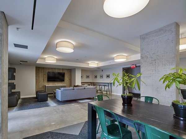 Elegant clubhouse with modern seating at VINE Apartments, a Greystar property offering luxury living