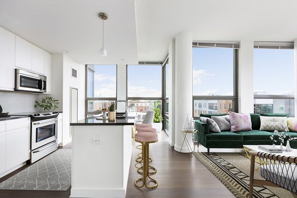 Dining room with modern decor and large windows at VINE Apartments, luxurious living in the heart of the city