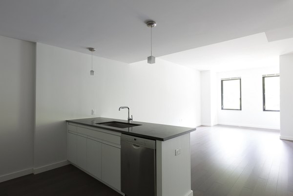 Elegant dining room with modern furniture at VINE Apartments, offering luxury living in a prime location