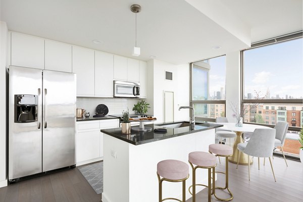 Modern kitchen with stainless steel appliances at VINE Apartments