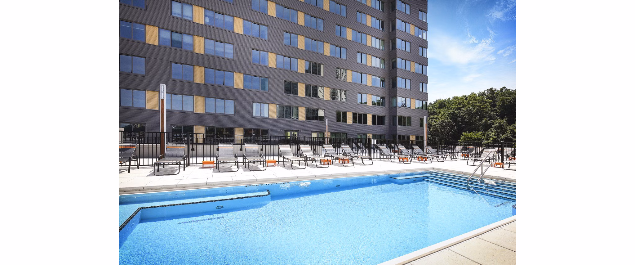 Relaxing poolside experience at VINE Apartments, a Greystar luxury community, with modern lounges and tranquil atmosphere