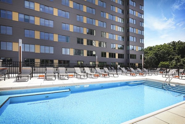 Relaxing poolside experience at VINE Apartments, a Greystar luxury community, with modern lounges and tranquil atmosphere
