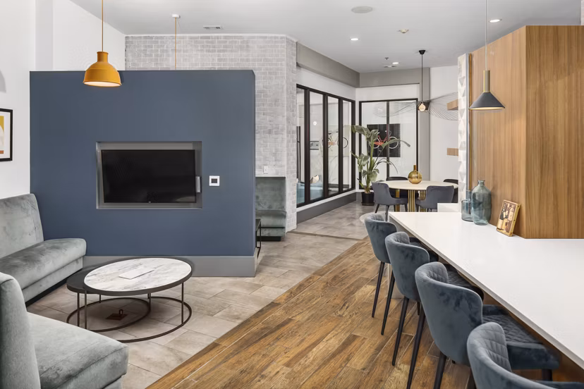 Clubhouse featuring modern design and seating at 1133 on the Square Apartments