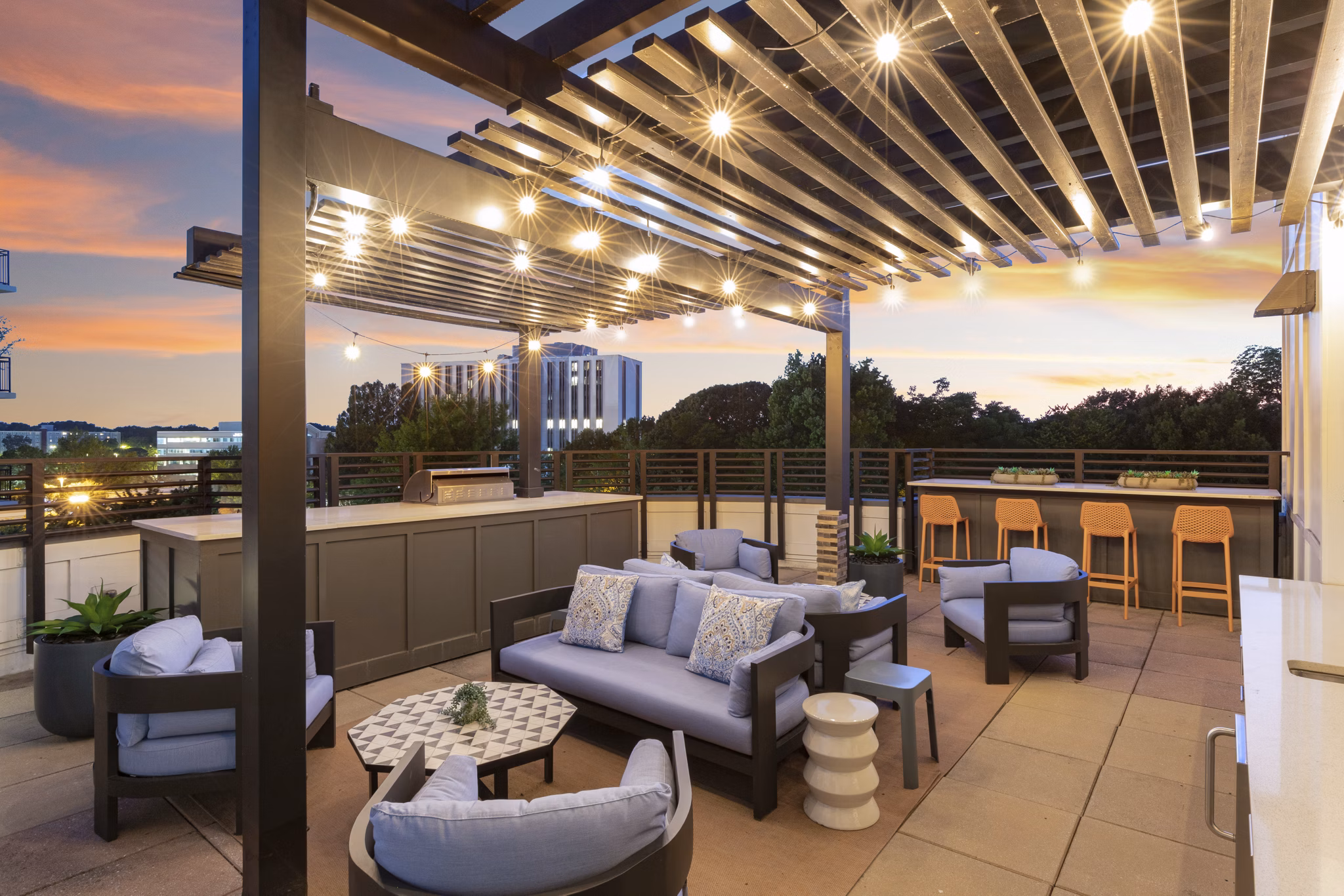 Clubhouse with modern seating and large screen TV at 1133 on the Square Apartments