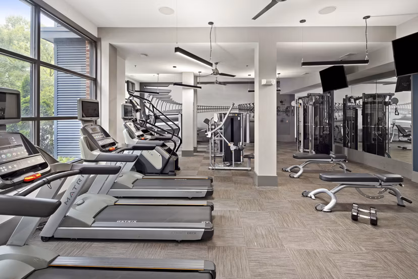 State-of-the-art fitness center at 1133 on the Square Apartments featuring modern equipment and spacious workout areas