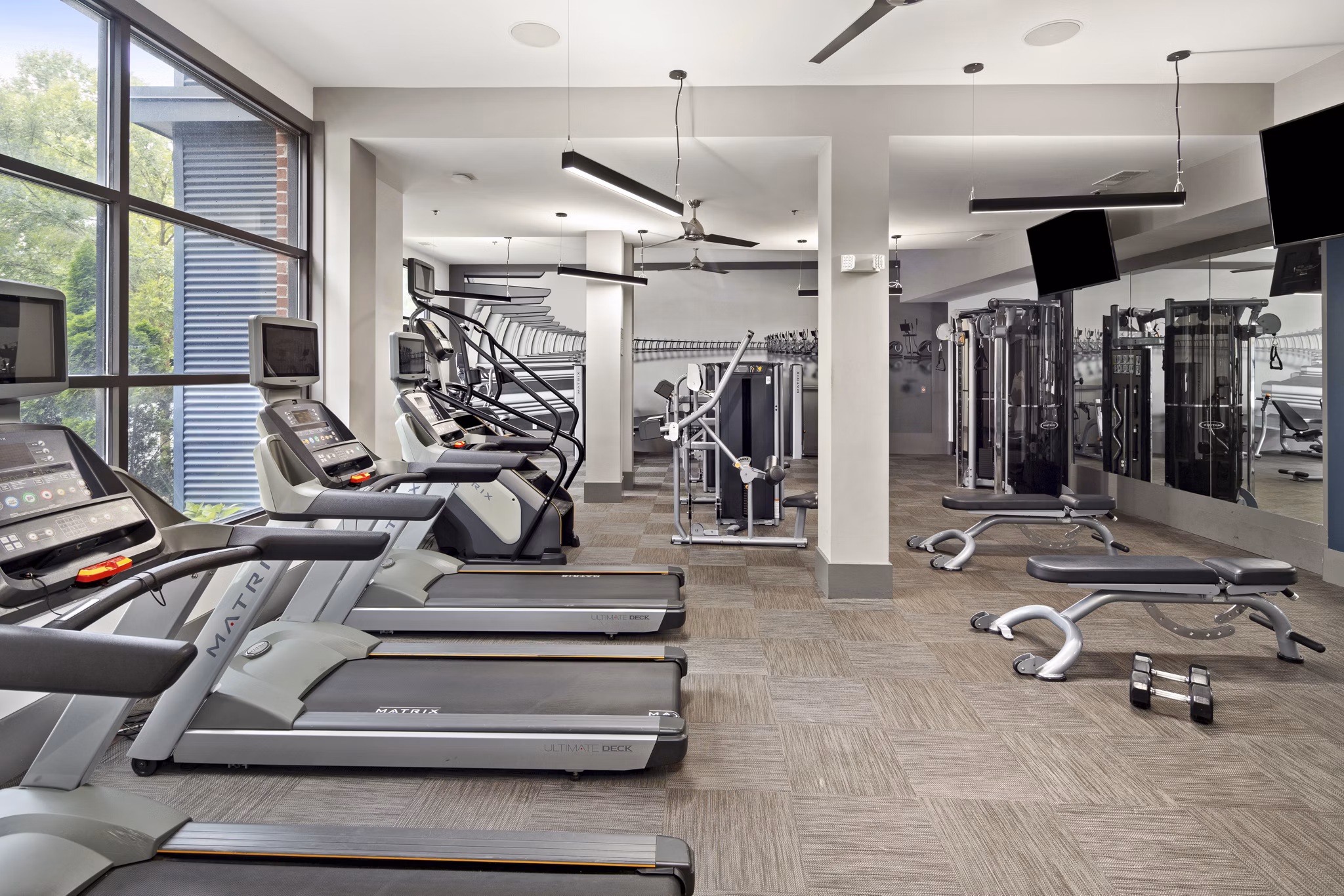 State-of-the-art fitness center at 1133 on the Square Apartments featuring modern equipment and spacious workout areas