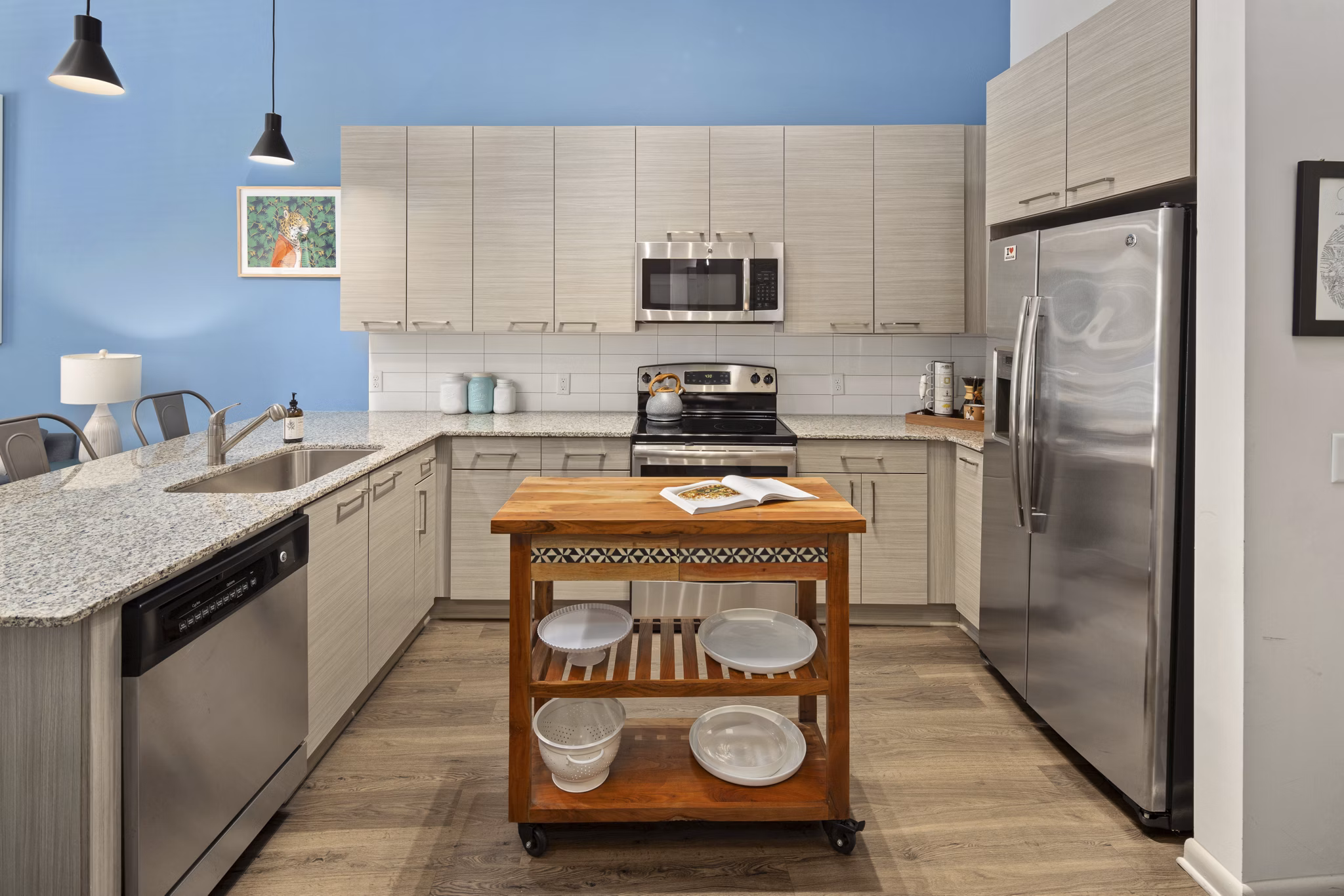 Modern kitchen with stainless steel appliances at 1133 on the Square Apartments