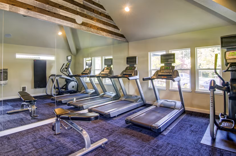 Modern clubhouse with stylish seating and game area at Heatherbrae Commons Apartments, providing a luxury lifestyle experience
