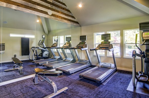 Modern clubhouse with stylish seating and game area at Heatherbrae Commons Apartments, providing a luxury lifestyle experience