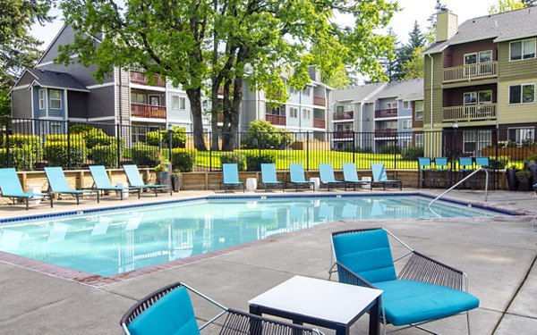 Outdoor pool at Heatherbrae Commons Apartments with lounge seating and landscaped surroundings