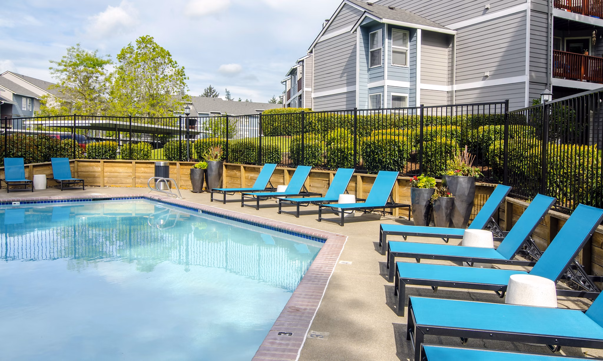 Poolside relaxation at Heatherbrae Commons Apartments: Stylish pool area with lounge chairs perfect for summer enjoyment