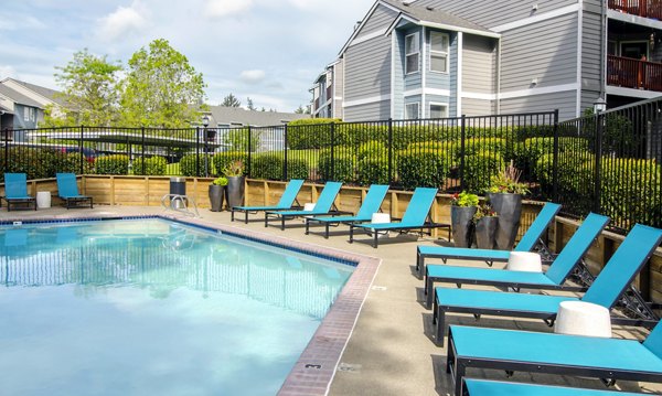 Poolside relaxation at Heatherbrae Commons Apartments: Stylish pool area with lounge chairs perfect for summer enjoyment