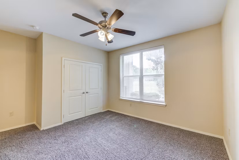 Bedroom with modern decor and large windows in Overture Ridgmar Apartments