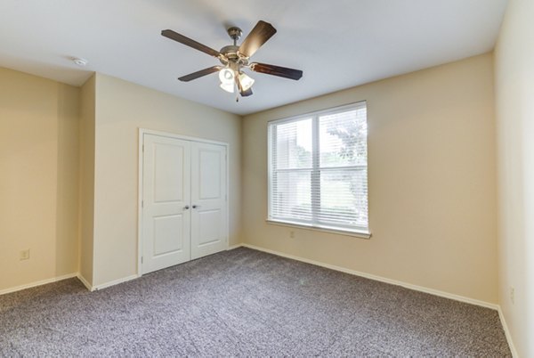 Bedroom with modern decor and large windows in Overture Ridgmar Apartments