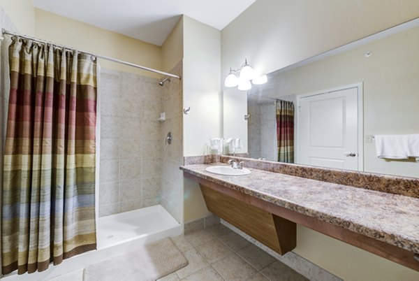 Modern bathroom with sleek fixtures and spacious vanity in Overture Ridgmar Apartments