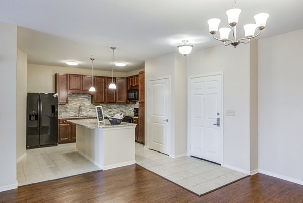 Modern kitchen featuring stainless steel appliances and granite countertops in Overture Ridgmar Apartments