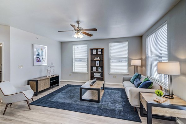 Spacious living room with modern decor and large windows at Overture Ridgmar Apartments