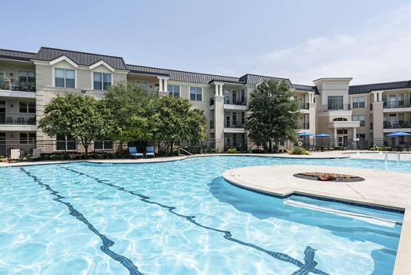 Poolside relaxation area with lounge chairs at Overture Ridgmar Apartments, offering luxury living amenities in a vibrant community