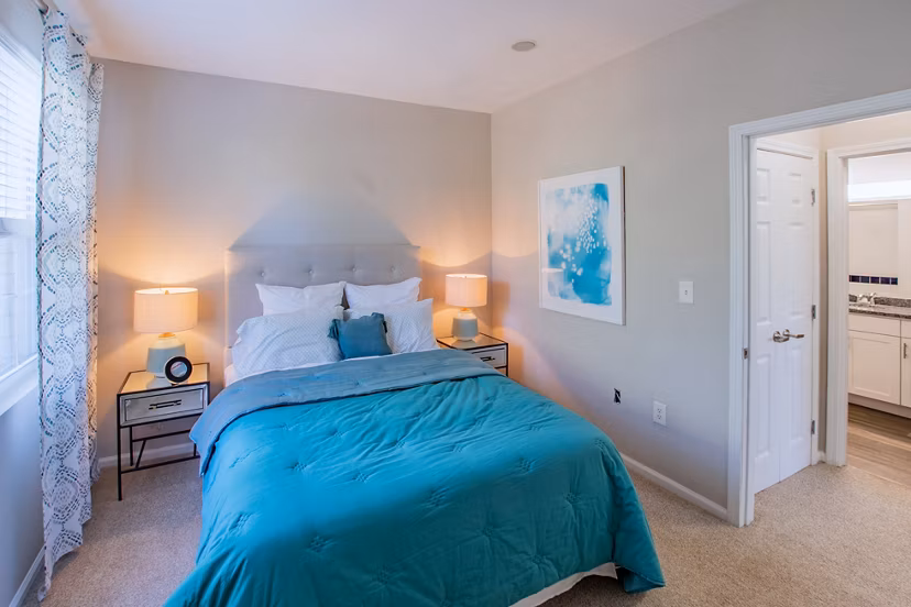 Cozy bedroom with plush bedding and natural light at The Retreat at Marlborough