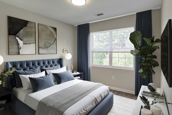 Cozy bedroom with plush bedding and natural light at The Retreat at Marlborough