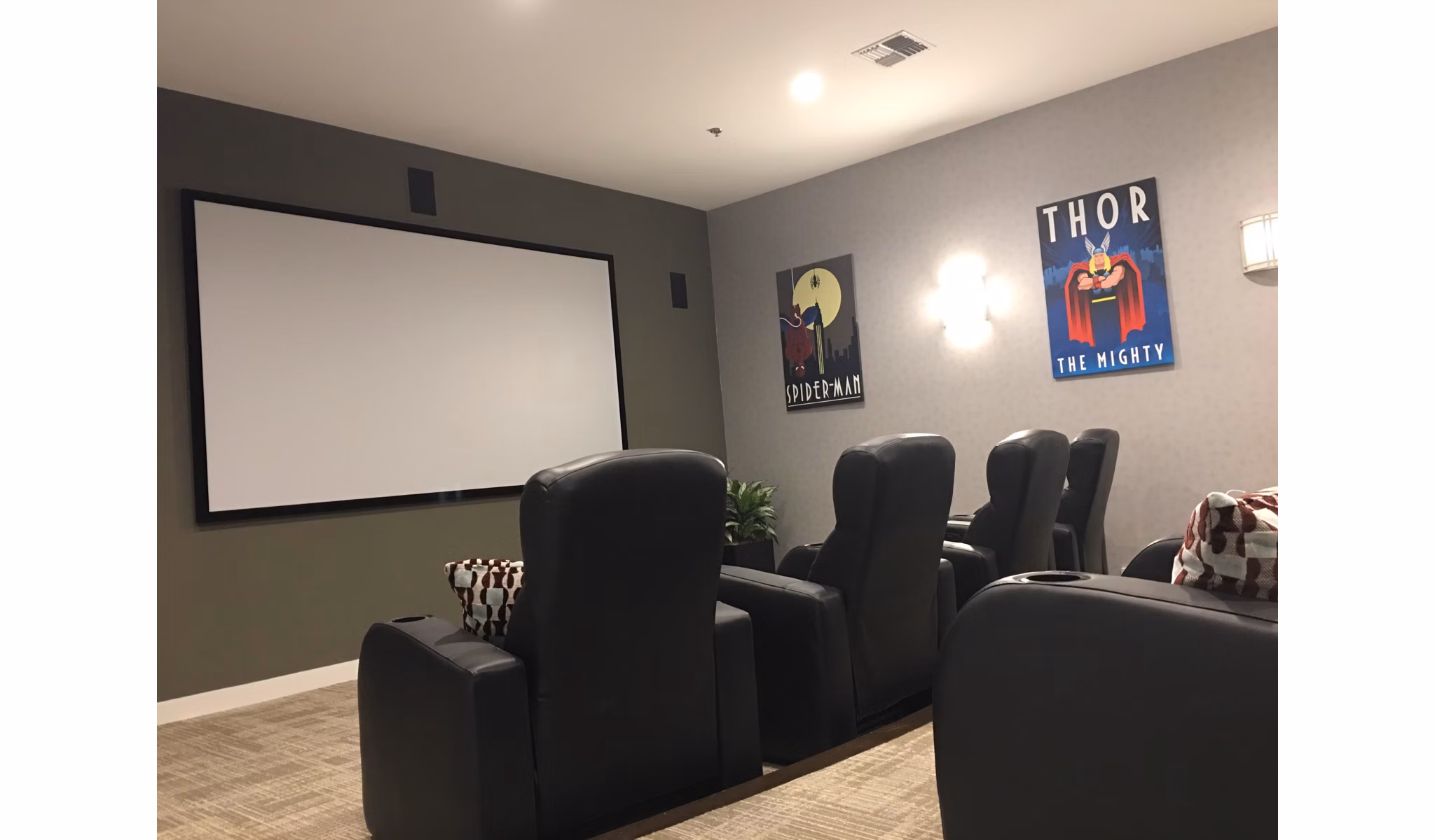 Heights at Wheeler Hill Apartments: Theater room with plush seating and large screen for luxury entertainment experience