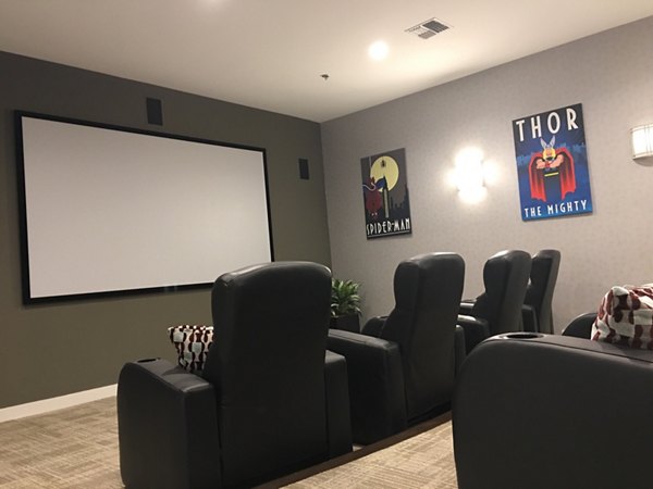 Heights at Wheeler Hill Apartments: Theater room with plush seating and large screen for luxury entertainment experience